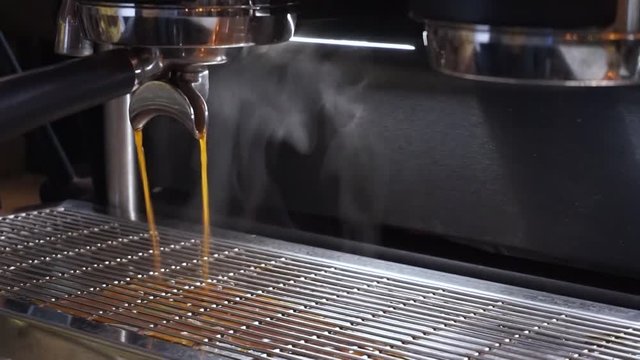 Professional coffee machine spilling double espresso coffee