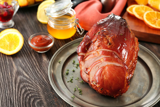 Metal plate with traditional honey baked ham on table