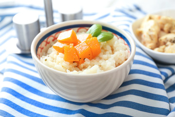 Bowl with delicious pumpkin risotto on table
