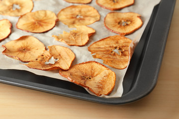 Tasty apple chips on baking tray