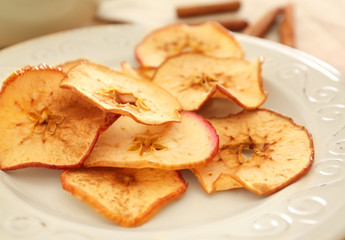 Tasty apple chips on plate