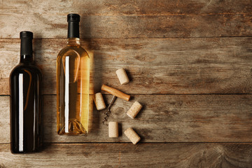 Obraz na płótnie Canvas Bottles of wine and corks on wooden background