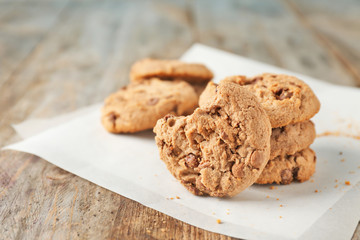 Delicious oatmeal cookies with chocolate chips on wooden table