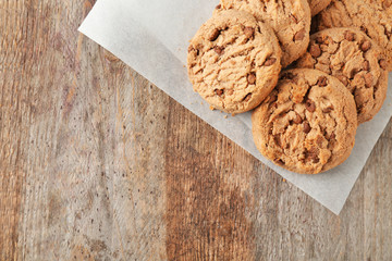 Delicious oatmeal cookies with chocolate chips on wooden table