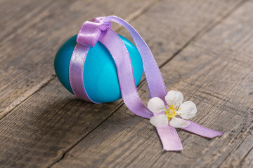 Colorful festive easter egg, tied with a ribbon