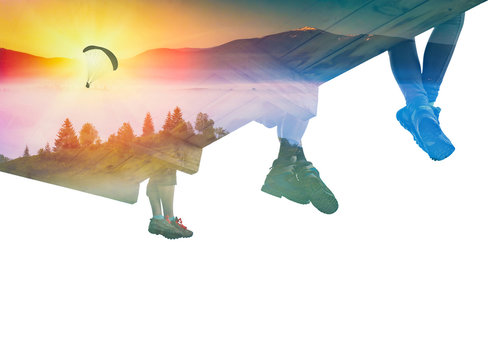 Paraglide silhouette in a sky and group of hikers