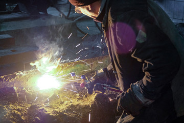 the welder welds metal structures