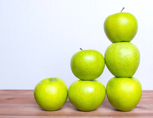 Many apples on the wooden table.
