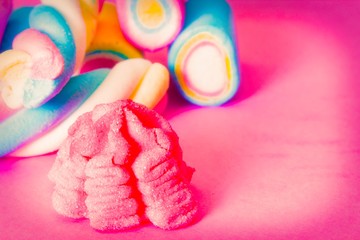 sweet. colored marshmallows on pink background