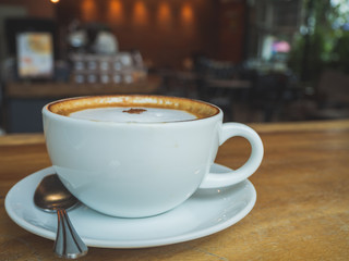 Coffee Time. Cappuccino with smartphone. on Wooden table in coffee shop. Cup of coffee in coffee shop. Empty cup of coffee.