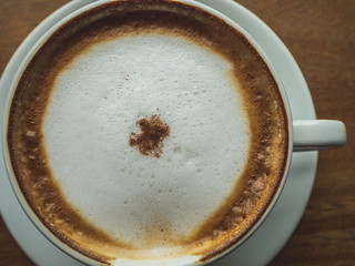 Coffee Time. Cappuccino with smartphone. on Wooden table in coffee shop. Cup of coffee in coffee shop. Empty cup of coffee.