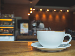 Coffee Time. Cappuccino with smartphone. on Wooden table in coffee shop. Cup of coffee in coffee shop. Empty cup of coffee.