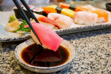 close up sushi sashimi set with chopsticks and soy sauce