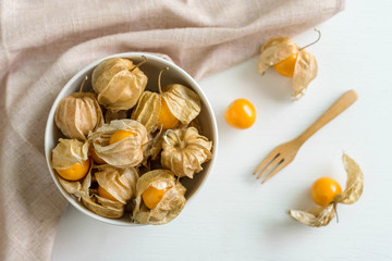 Cape gooseberry fruit on white wooden background