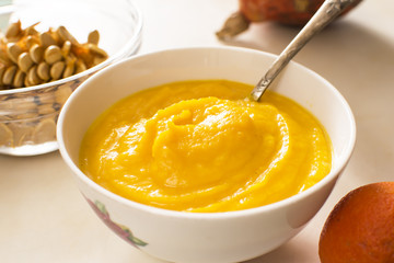 orange cream soup in a bowl, on a table
