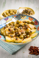 potatoes salad with green olives capers and hot chili pepper, selective focus