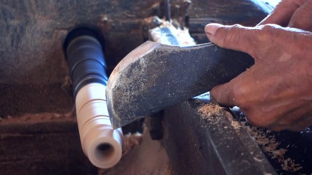 Skilled artisan working of wooden piece