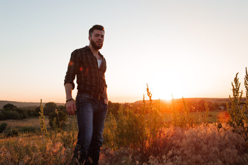 Handsome man on sunset background