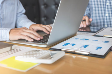 Business team two executive colleagues discussing and analysis working Financial investment on calculator with calculate on tablet Analyze business and market growth on financial document data graph