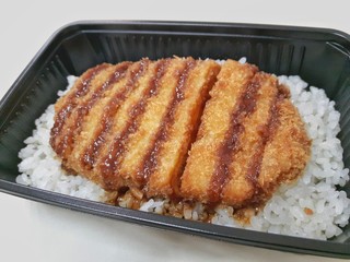 Tonkatsu, fried pork topped with sweet sauce on rice.