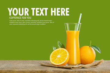 Glass of fresh orange juice on wooden table, Fresh fruits Orange juice in glass with group on green background with copy Space for your text.