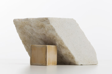 Composition with marble rock and small wooden cube on white desk, workspace decoration, minimal style