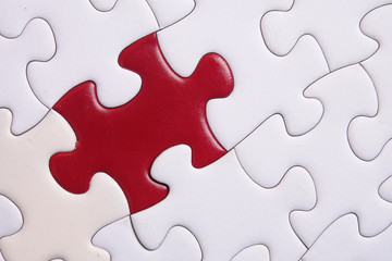 Red puzzle on white background. Copy space