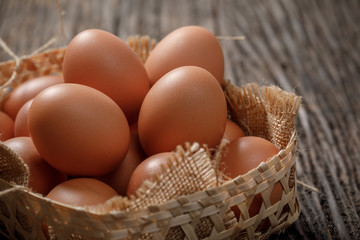 Brown Egg in a basket on wooden table, Chicken Egg