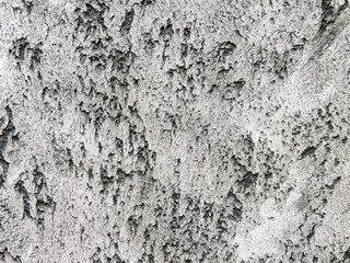 texture plaster,  loft style, wall of the building plastered black and white stucco with glitter in the Venetian technique, travertine stone, l