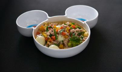 egg vegetable and pork soup on black background