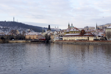Fototapeta premium Snowy Prague Lesser Town with St. Nicholas' Cathedral, Czech republic