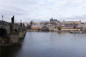 Snowy Prague Lesser Town with Prague Castle, St. Nicholas' Cathedral and Charles Bridge, Czech republic