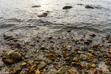 Rock on the beach with hard light