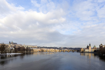 Snowy Prague Lesser Town with Prague Castle, St. Nicholas' Cathedral and Charles Bridge, Czech republic