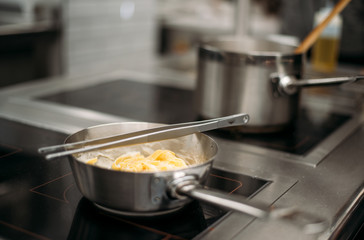Restaurant kitchen and cook at work