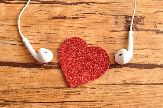 White earphones with a red heart