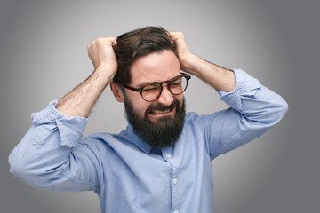 Frustrated bearded man in glasses