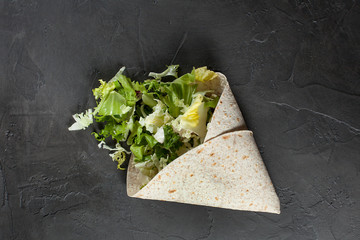 Lavash with herbs with olive oil and spices on a dark background