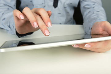 Fototapeta premium Woman using a touch screen tablet hands
