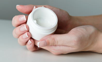 beautiful woman hands with cream