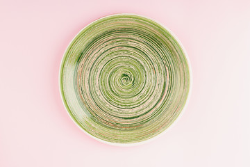 Green plate on the light pink background