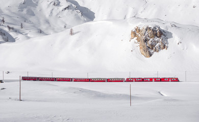 Bernina red train in snowy landscape