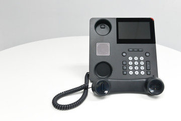 Black IP Phone, Office phone on the white table in the meeting room