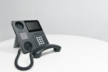 Black IP Phone, Office phone on the white table in the meeting room