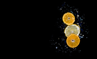 fruits in water on black backround