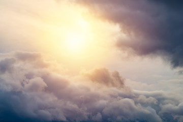 Sun shines through a gray thunder clouds