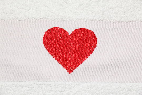 Embroidered red heart on a white background