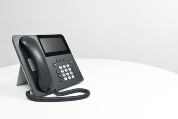 Black IP Phone, Office phone on the white table in the meeting room
