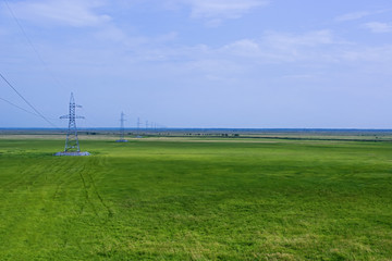 Fototapeta na wymiar Overhead power line on the plain.