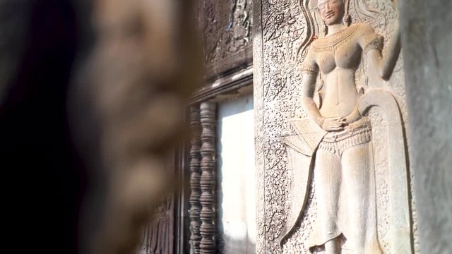 Steadicam gimbal push in of apsara dancer on the wall of Angkor Wat.